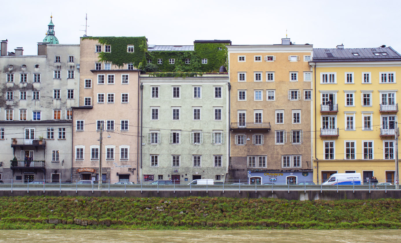 Pastel buildings along the river in Salzburg, Austria